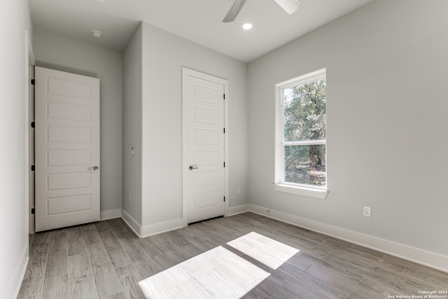 unfurnished bedroom featuring a closet, ceiling fan, and light hardwood / wood-style flooring