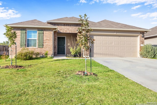 single story home featuring a garage and a front lawn