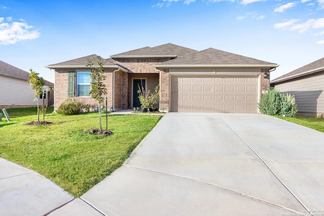 view of front of property with a front yard and a garage