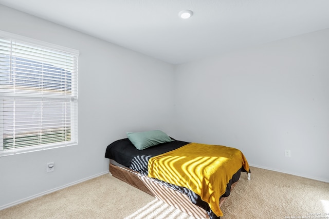 carpeted bedroom featuring multiple windows