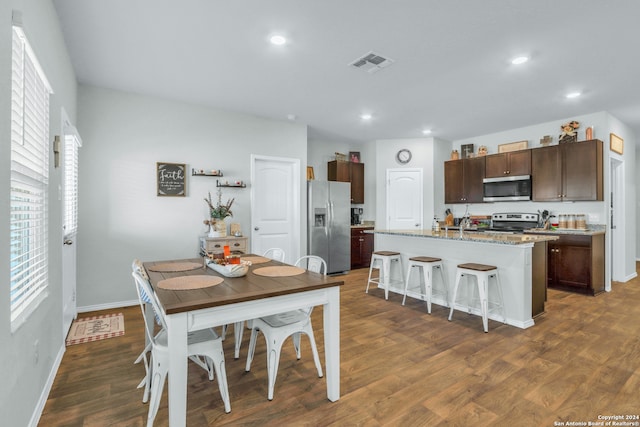 dining space featuring dark wood-type flooring