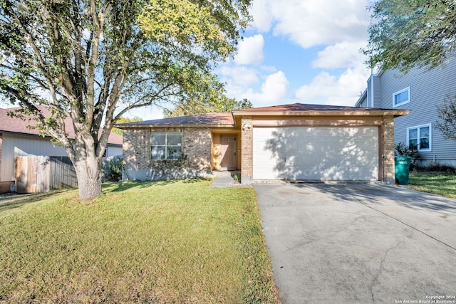 ranch-style home with a front yard and a garage