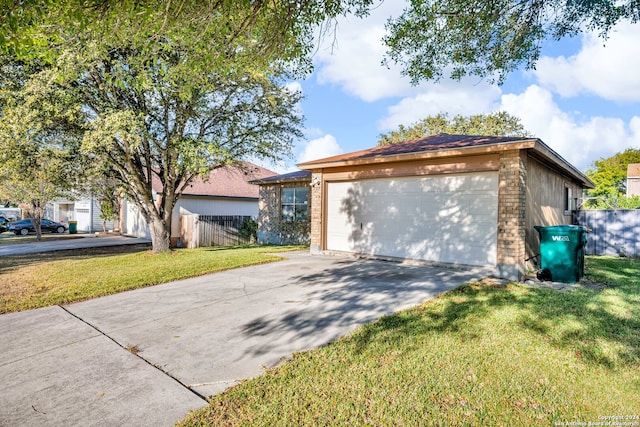 view of front facade with a front yard, a garage, and an outdoor structure