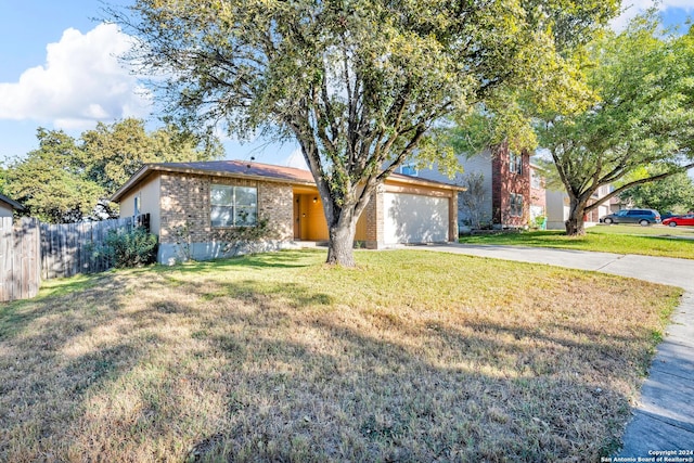 ranch-style home with a garage and a front lawn