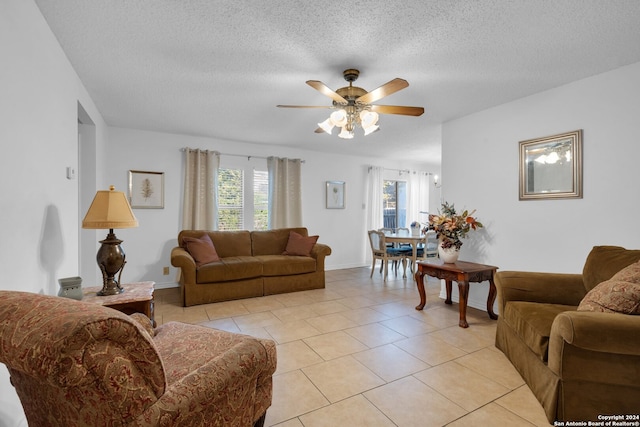 tiled living room featuring ceiling fan and a textured ceiling