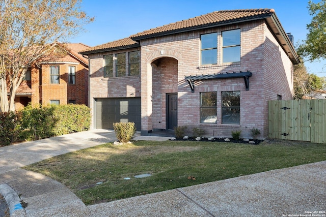 view of front of property featuring a garage and a front yard