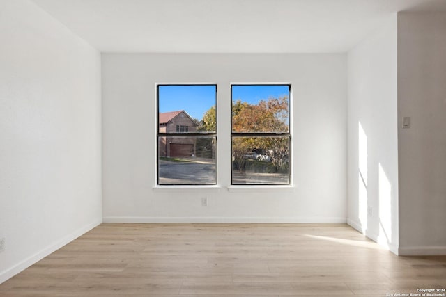 unfurnished room featuring light hardwood / wood-style flooring