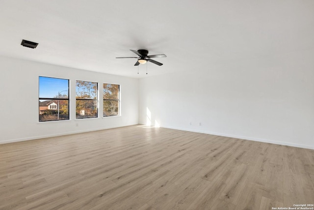 empty room featuring light wood-type flooring and ceiling fan