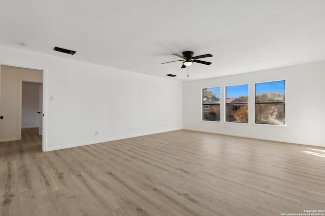 spare room featuring ceiling fan and light wood-type flooring