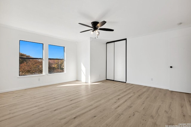 spare room with light hardwood / wood-style flooring, ceiling fan, and ornamental molding