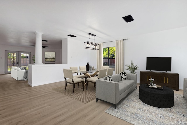 living room featuring ceiling fan, french doors, and light hardwood / wood-style flooring