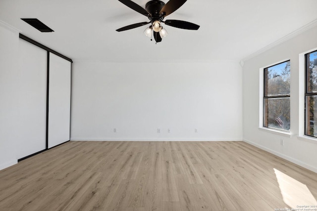 unfurnished bedroom with ceiling fan, light hardwood / wood-style floors, crown molding, and a closet