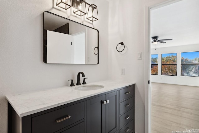 bathroom featuring wood-type flooring, vanity, and ceiling fan