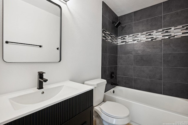 full bathroom with vanity, tiled shower / bath combo, and toilet