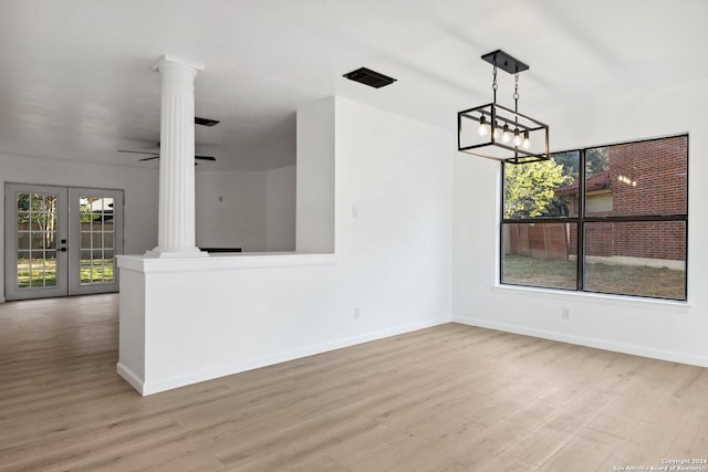 interior space with french doors, ceiling fan with notable chandelier, light hardwood / wood-style floors, and ornate columns