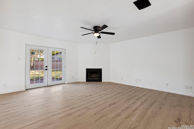 unfurnished living room featuring french doors, light wood-type flooring, and ceiling fan