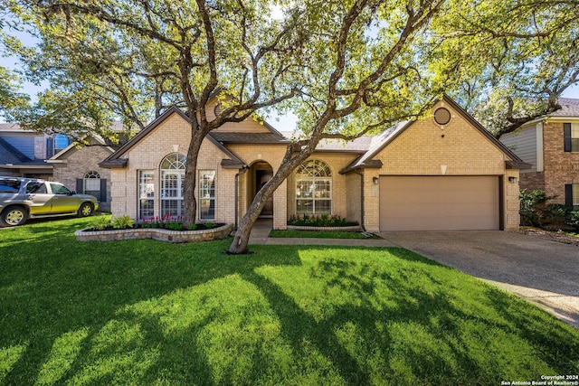 view of front of house with a garage and a front lawn