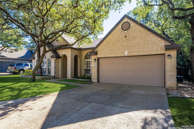 view of front of house featuring a garage and a front lawn