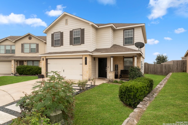 view of front of property with a front yard and a garage