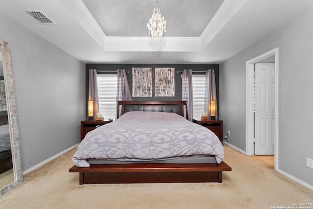 bedroom featuring a chandelier, light colored carpet, a raised ceiling, and crown molding