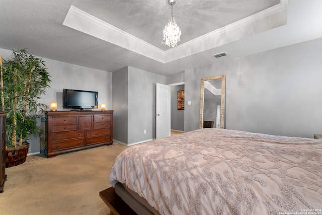 carpeted bedroom with a textured ceiling, a raised ceiling, crown molding, and a chandelier