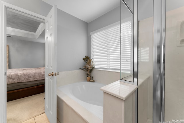 bathroom featuring tile patterned flooring and independent shower and bath