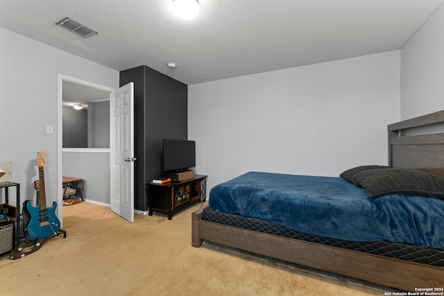 carpeted bedroom with a textured ceiling