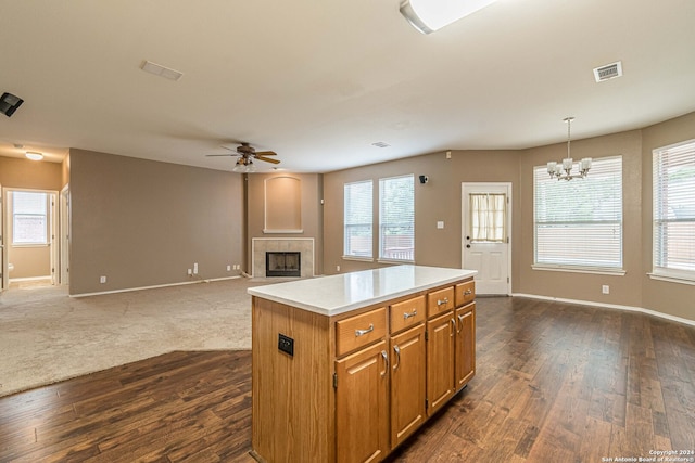 kitchen featuring pendant lighting, a kitchen island, and a healthy amount of sunlight