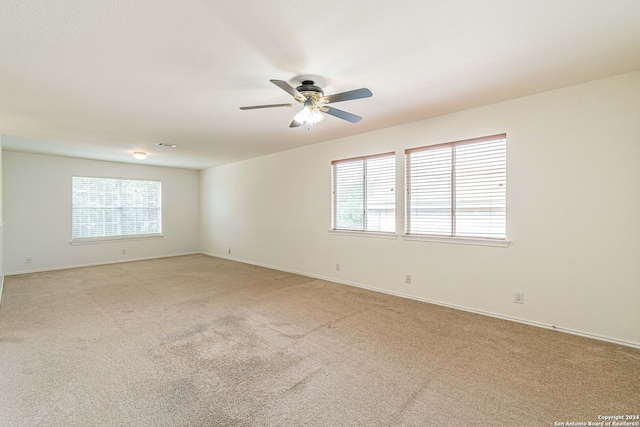 spare room with light carpet and ceiling fan