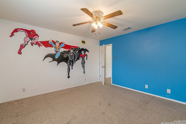 empty room with ceiling fan and carpet