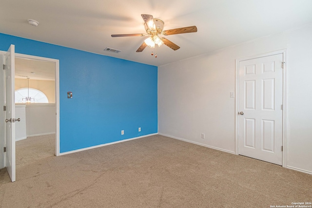 unfurnished room with ceiling fan and light colored carpet