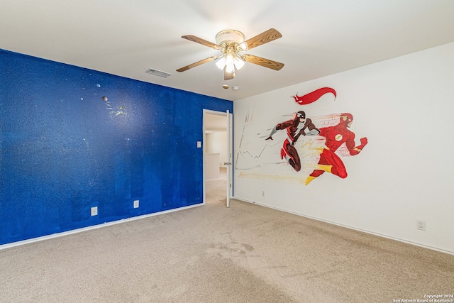 carpeted spare room with ceiling fan