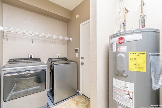 laundry room with washing machine and clothes dryer and water heater