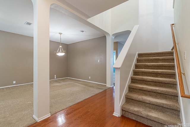 staircase featuring wood-type flooring