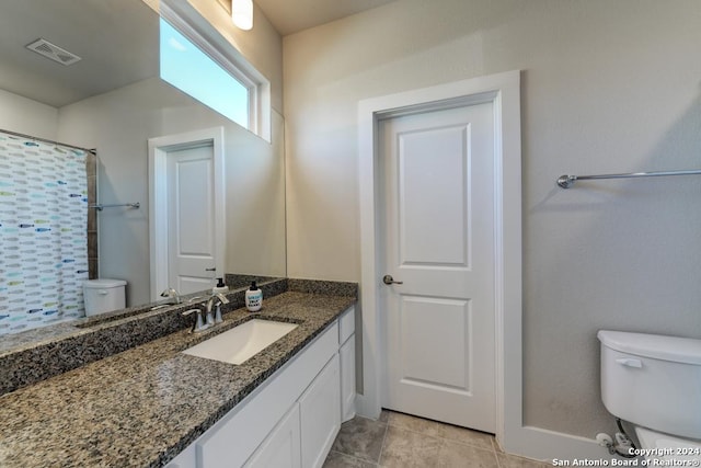 bathroom with walk in shower, vanity, and toilet