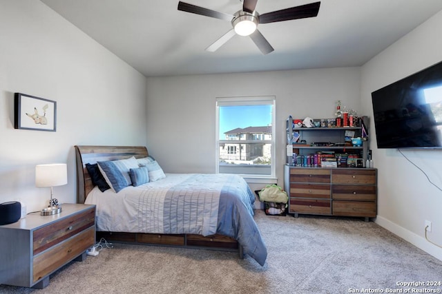 bedroom featuring light colored carpet and ceiling fan