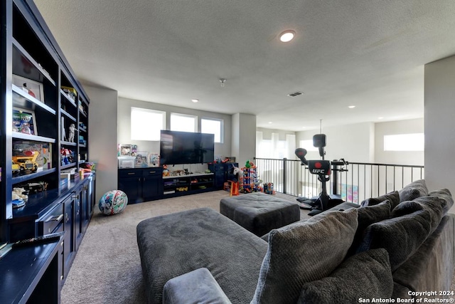 carpeted living room featuring a textured ceiling