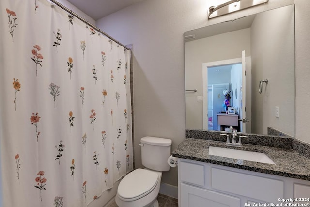 bathroom featuring vanity, walk in shower, and toilet