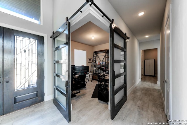 foyer featuring plenty of natural light and a barn door