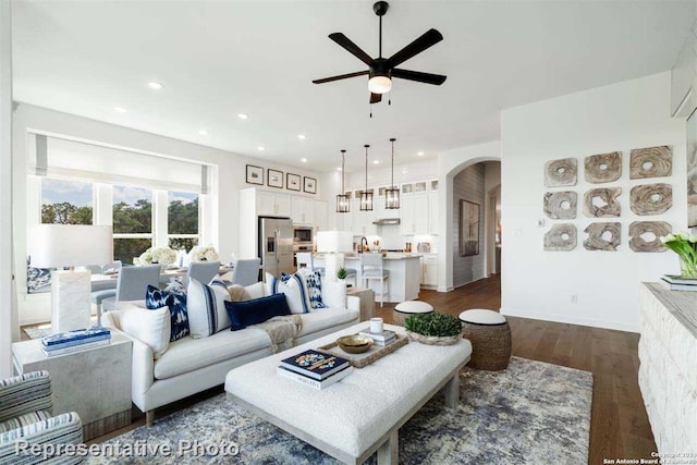 living room with ceiling fan and dark hardwood / wood-style floors