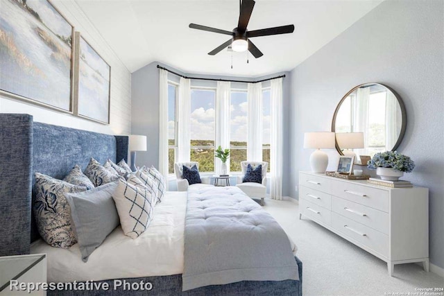 bedroom with ceiling fan, light colored carpet, and lofted ceiling