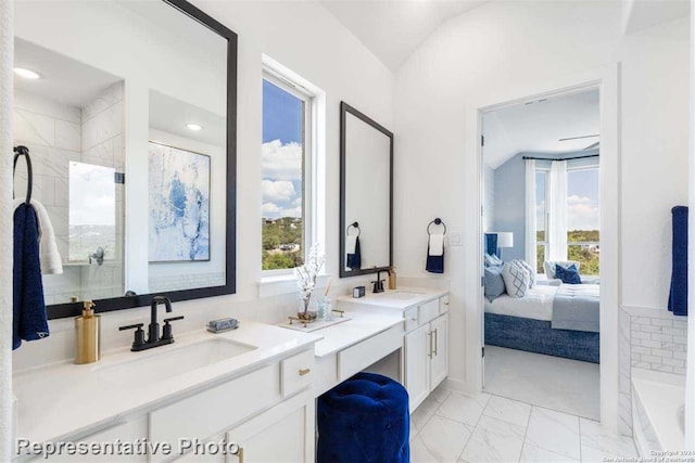 bathroom featuring vanity and lofted ceiling