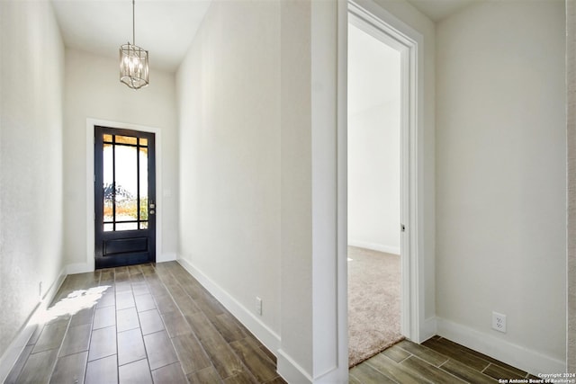 entrance foyer featuring a notable chandelier and dark wood-type flooring