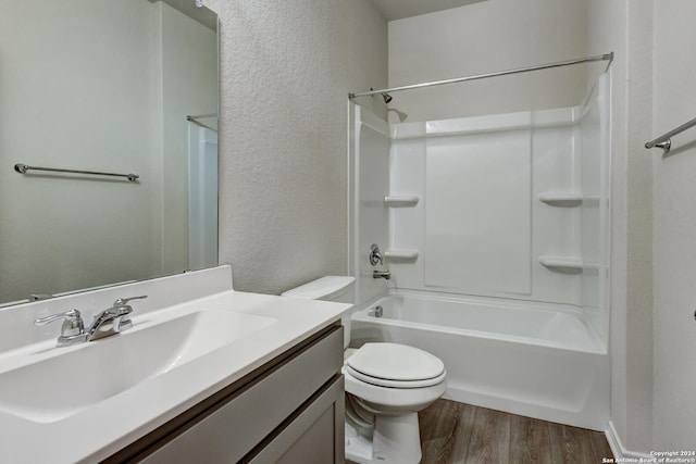 full bathroom featuring shower / bathing tub combination, wood-type flooring, vanity, and toilet