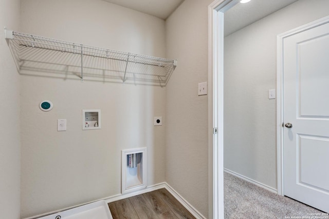 laundry room featuring hardwood / wood-style flooring, electric dryer hookup, gas dryer hookup, and hookup for a washing machine