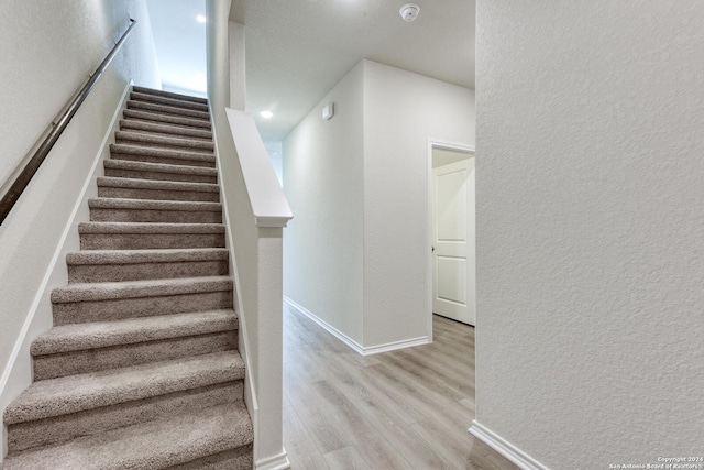 stairs with hardwood / wood-style floors