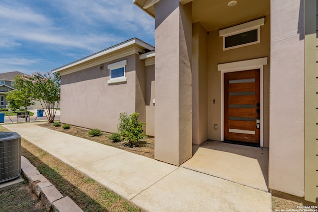 property entrance featuring central AC unit