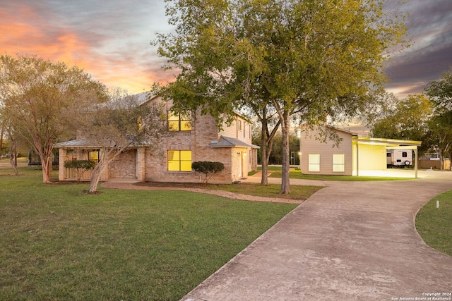 view of front of property featuring a carport and a yard