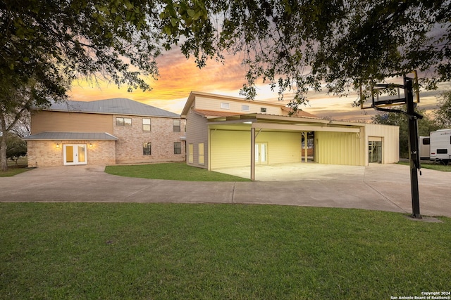 view of front facade featuring a carport and a lawn