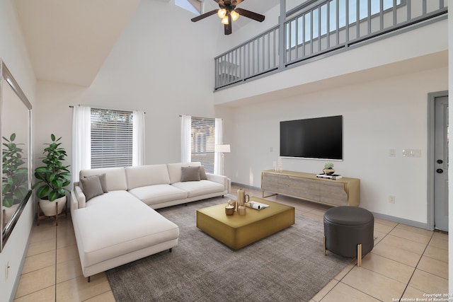 tiled living room with ceiling fan and a towering ceiling